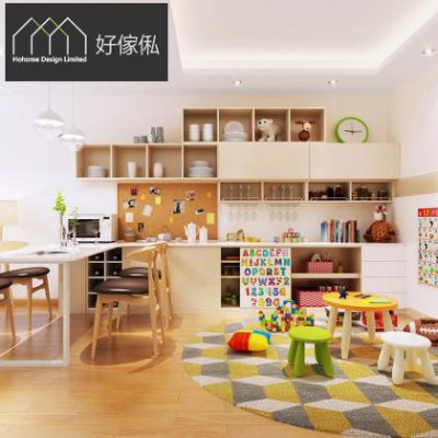 開放式廚房連飯廳效果圖，淺木紋L形廚櫃連白色檯面同軟木留言板，上方一排木紋吊櫃連開放格擺放白色碗碟、玻璃杯同調味樽，左邊白色長餐枱配木腳餐椅同球形吊燈，地面木地板鋪黃灰菱格圓地毯，放有兒童小圓凳同積木，左上角有好傢俬 HoHome 標誌。
