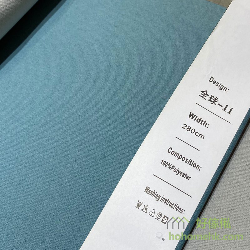 斜紋平板布窗簾11號色布料近距特寫，標籤顯示「全球-11」及100%Polyester，布面呈細密斜紋素色設計